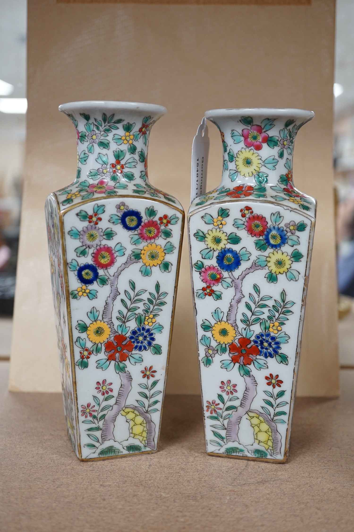 A pair of Japanese floral enamelled square tapering porcelain vases, 18cm high. Condition - good